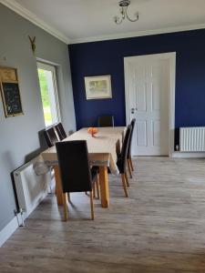 a dining room with a table and chairs at Beech lodge in Wexford