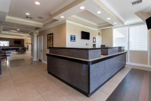 a large lobby with a reception desk in a building at Travelodge by Wyndham Lakeland in Lakeland