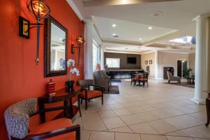 a living room with red walls and chairs at Travelodge by Wyndham Lakeland in Lakeland