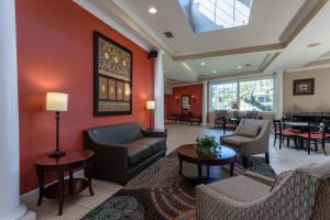 a lobby with a couch and chairs and tables at Travelodge by Wyndham Lakeland in Lakeland