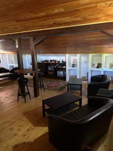 a living room with a couch and a table at La Păstrăvărie ,,Casa Iov,, in Moroeni