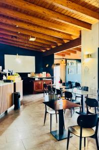 a restaurant with tables and chairs and a kitchen at Hotel Gallia in Pianezza +25 photos