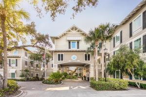 a building with palm trees in front of it at Hampton Inn New Smyrna Beach in New Smyrna Beach