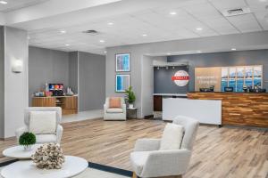 a waiting room with chairs and a projection screen at Hampton Inn New Smyrna Beach in New Smyrna Beach +53 photos