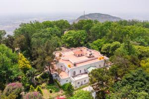 an aerial view of a mansion in the trees at KSTDC Hotel Mayura Pine Top Nandi Hills in Nandi