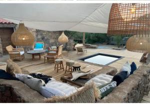 a patio with a couch and a swimming pool at Casa Olea in Sartène