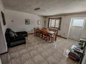 a living room with a dining room table and chairs at Artemis Vendégház in Bogács