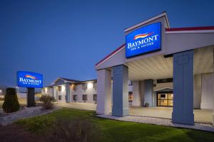 a building with a sign for a hotel at Baymont by Wyndham Waukesha in Waukesha