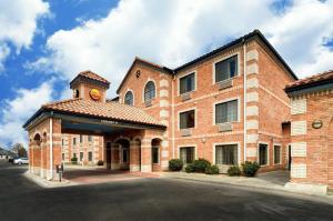 a large brick building with a clock tower on it at Comfort Inn & Suites Amarillo West Near Medical Center in Amarillo