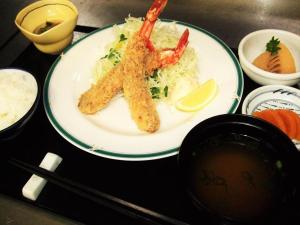 a plate of food with shrimp and rice and a lemon at Minami Hakone Villa in Kannami