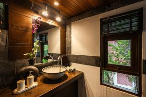 a bathroom with a sink and a mirror at Beyond The Blue Horizon Boutique Bungalows in Haad Chao Phao +54 photos