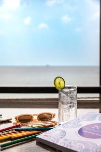 a glass of water with a lime on a table at Beyond The Blue Horizon Boutique Bungalows in Haad Chao Phao