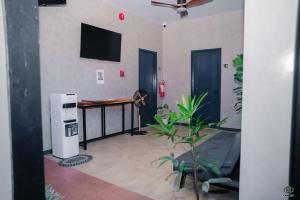 a room with a desk and a television in a room at Luna Vista Tourist Inn in Puerto Princesa City