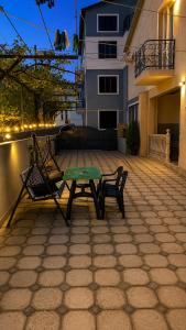 a green table and two chairs on a patio at KOTEJ UREKI in Ureki