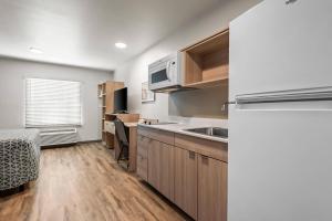 a kitchen with a sink and a microwave at WoodSpring Suites Lancaster North in Lancaster