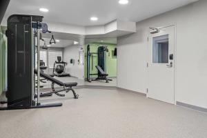 a gym with treadmills and machines in a room at WoodSpring Suites Lancaster North in Lancaster