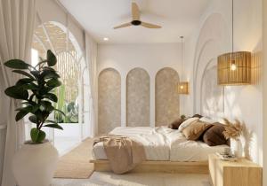 a bedroom with a bed and a ceiling fan at Svara Boutique Residences in Uluwatu