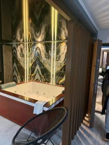a room with a tub in a wall at Regim Hotel Hanea jacuzzi in camera,piscina exterioara si sauna comuna in Sibiu