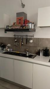 a kitchen with white cabinets and a stove top oven at Chez Anna in Iesi