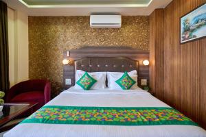 a hotel room with a bed and a chair at Treebo Roshan House Near Mcleodganj in McLeod Ganj +46 photos