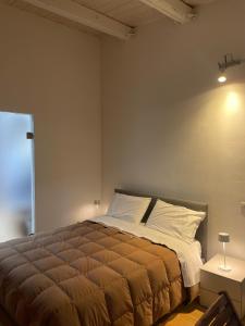 a bedroom with a large bed and a window at Chez Anna in Iesi