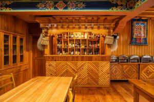 a dining room with a table and a bar at Valley Resort in Jakar