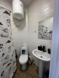 a bathroom with a toilet and a sink at YARNA rooms by sea in Odesa +36 photos