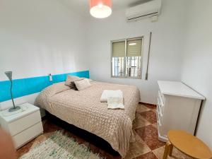 a bedroom with a bed and a table and a window at La Casa del Flamenco in Cañada del Rabadán +87 photos