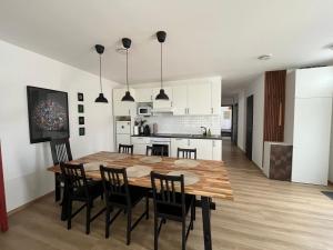 a kitchen and dining room with a wooden table and chairs at Ala'Toboz Siófok in Siófok