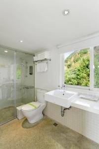 a bathroom with a toilet and a sink and a shower at Golden101 Bed and Breakfast in Jiufen +67 photos