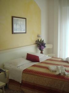 Uma cama ou camas num quarto em Hotel Arcade