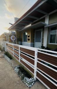 a wooden fence in front of a house at Skys Transient House Unit 1 in Manolo Fortich