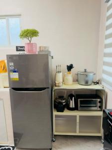 a kitchen with a stainless steel refrigerator and a counter at Skys Transient House Unit 1 in Manolo Fortich