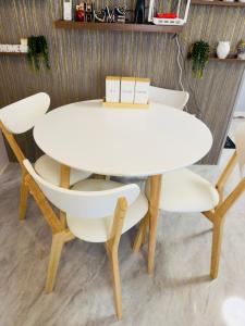a white table and chairs in a room at Skys Transient House Unit 1 in Manolo Fortich +8 photos