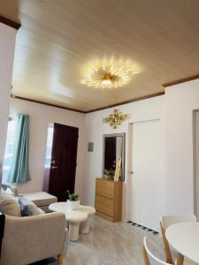 a living room with a couch and a ceiling at Skys Transient House Unit 1 in Manolo Fortich