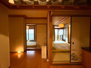 a room with two beds and a mirror at Just a short walk 心斎橋 Glico Sign 1min 道頓堀30-second 黒門市場 難波駅 Dotonbori Guesthouse 松の阁 in Osaka