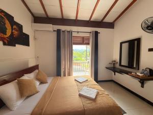 a bedroom with a large bed with a window at Maya 44 Boutique Ella in Ella