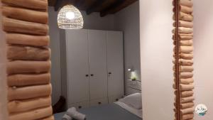 a bedroom with white cabinets and a mirror at In Alto in Plaka Milou +66 photos