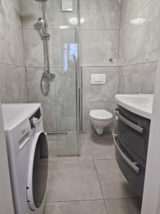 a bathroom with a shower and a toilet and a sink at Apartments Jelinek in Brela +46 photos
