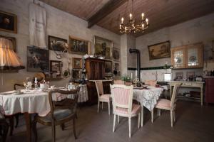 a dining room with tables and chairs and a chandelier at Sonnenhof Plauen in Plauen