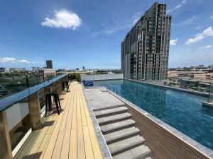 a swimming pool on the roof of a building at De Botan Bangna in Bangkok