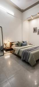 a bedroom with two beds and a mirror in it at Hotel blue moon in Shāmli