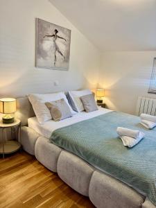 a bedroom with a large bed and two lamps at Apartments Toma in Novalja +85 photos