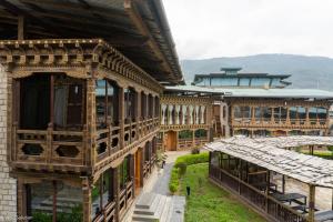 an old building with a garden in front of it at Phuntsho Guest House in Jakar