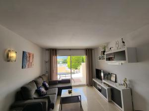 a living room with a couch and a tv at Ferienwohnung Lika in Cala Bona