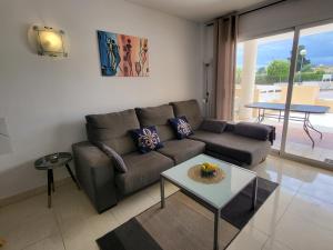 a living room with a couch and a table at Ferienwohnung Lika in Cala Bona