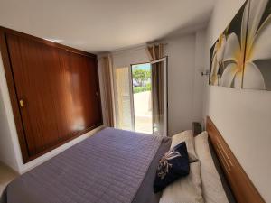 a bedroom with a bed and a large window at Ferienwohnung Lika in Cala Bona +22 photos
