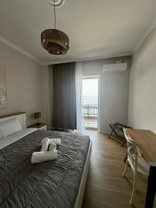 a bedroom with a bed with two towels on it at KAMVISSIS HOTEL in Tyros