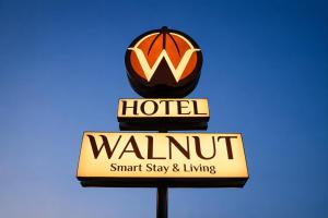 a sign for a hotel with a walmart sign at Hotel Walnut - Near Jaipur Airport in Jaipur