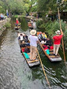 a group of people in boats on a river at Pilgrims Retreat in Kent